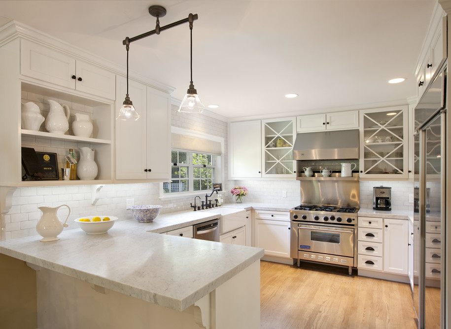 An all white and stainless steel kitchen with granite countertops from NEKA